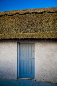 Closed door of thatched cottage