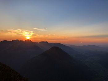 Scenic view of silhouette mountains against sky during sunset