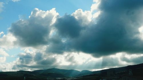 Scenic view of mountains against cloudy sky