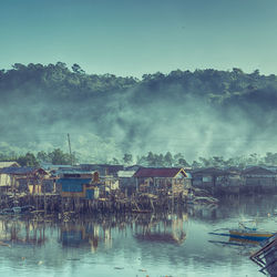 Panoramic view of lake and buildings against sky