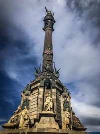 Low angle view of statue against cloudy sky