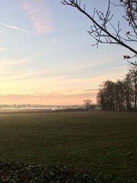 Scenic view of field against sky during sunset