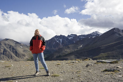 Portrait of woman standing on whistler mountain against sky