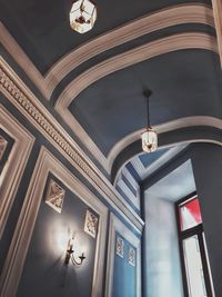Low angle view of illuminated chandelier hanging in building
