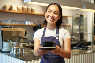 Portrait of young woman using mobile phone