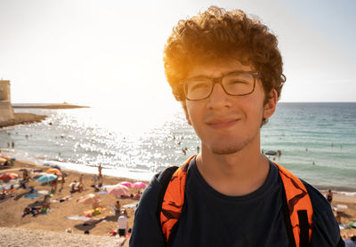 Portrait of young man against sea