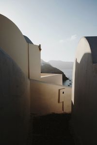 Buildings by sea against sky