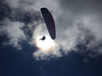 Low angle view of paraglider flying in sky