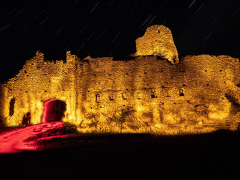 Low angle view of old building at night