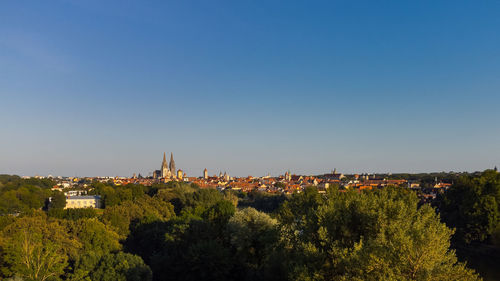Panoramic view of townscape against clear blue sky