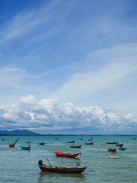 Boats in sea against sky