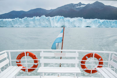 Boat trip in glacial lake against snowcapped mountains