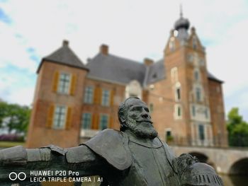 Low angle view of statue against building