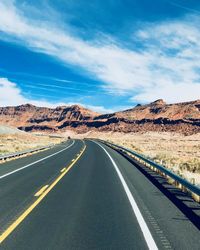 Empty road along countryside landscape