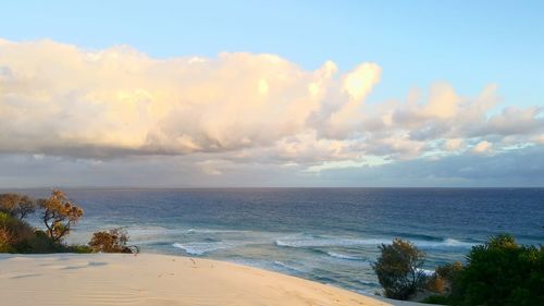 Scenic view of sea against cloudy sky