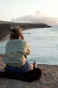 Woman/girl is enyoing the sunset in fuerteventura