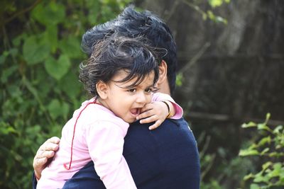 Portrait of father and daughter outdoors