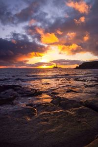 Scenic view of sea against cloudy sky