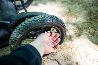 Close-up of hand holding tire