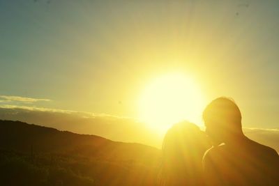 Woman against bright sun during sunset