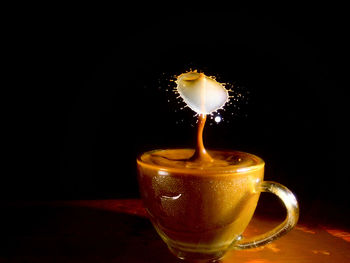 Close-up of coffee cup against black background