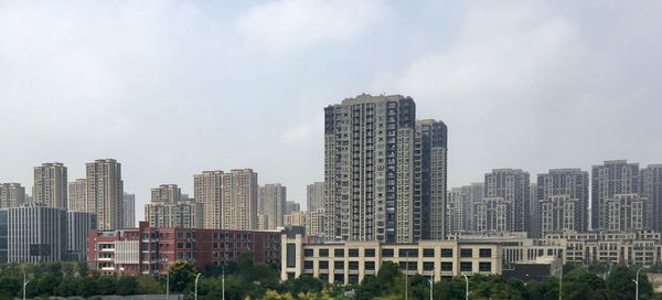 Modern buildings in city against sky