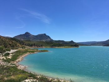 Scenic view of sea against clear blue sky