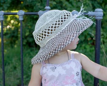 Rear view of child hat against trees