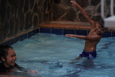 Boy swimming in pool at sea