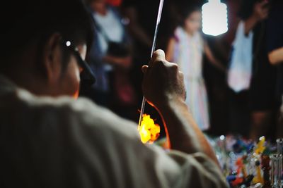 Rear view of people holding city at night