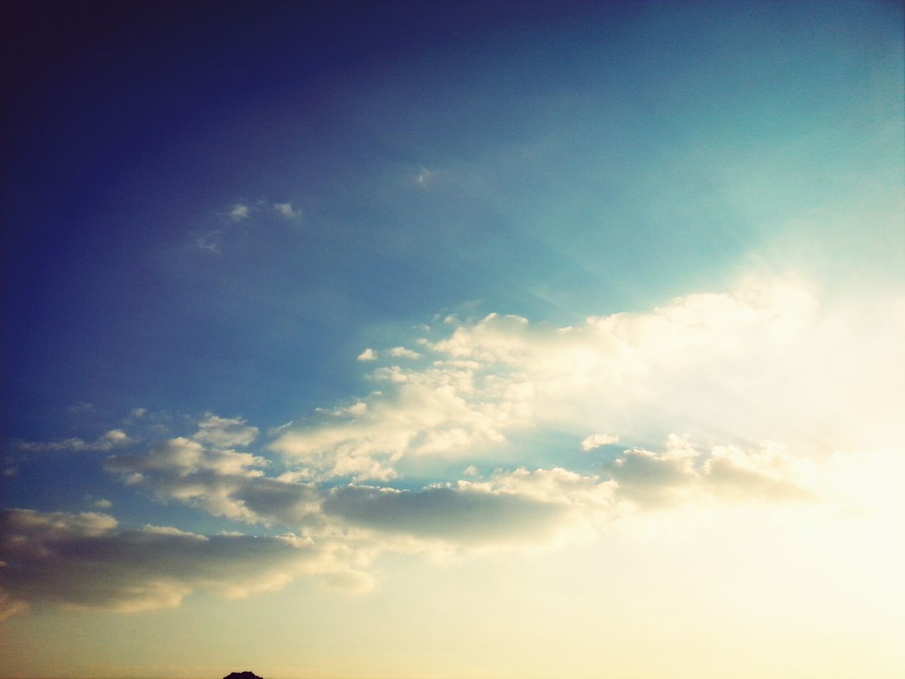 low angle view, sky, beauty in nature, cloud - sky, tranquility, scenics, sky only, tranquil scene, nature, blue, cloud, cloudscape, cloudy, idyllic, silhouette, outdoors, sunset, no people, backgrounds, sunlight