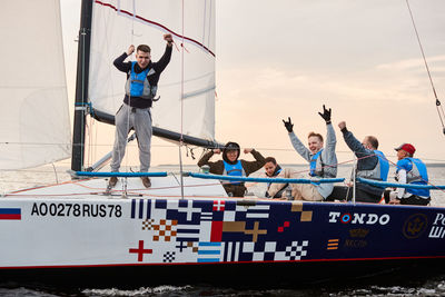 People standing on boat against sky