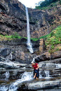 View of waterfall on rock