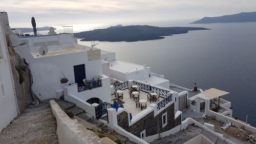 High angle view of buildings by sea against sky