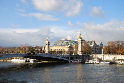 View of bridge over river against cloudy sky