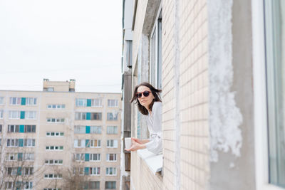 Portrait of woman looking out of window