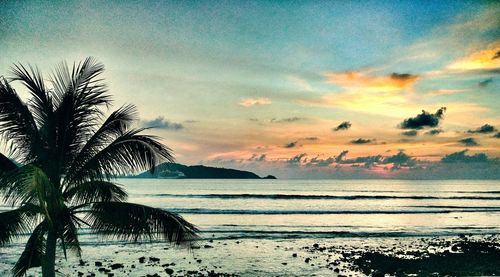 Scenic view of beach against sky during sunset