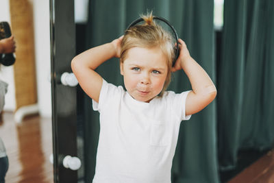 Portrait of cute girl standing at home