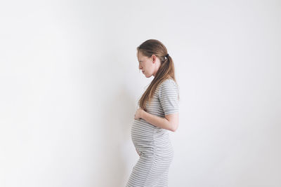 Pregnant woman in a grey dress
