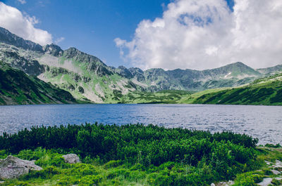 Scenic view of lake and mountains against sky