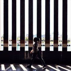Side view of woman standing in row