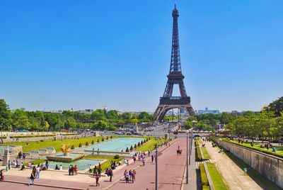 High angle view of tourists by eiffel tower against blue sky