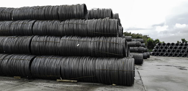 Stack of pipes against sky