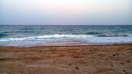 Scenic view of beach against clear sky