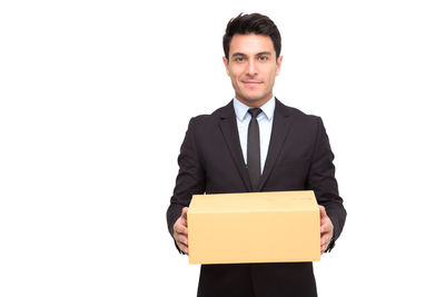 Portrait of a smiling young man against white background