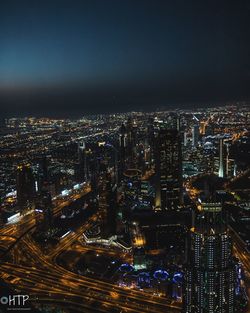 Illuminated cityscape against sky at night