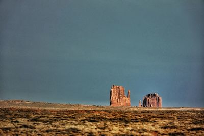 Rock formations on landscape against clear sky