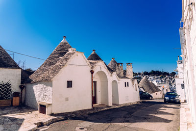 Panoramic view of buildings against clear blue sky