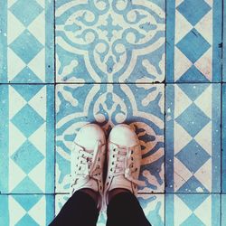 Low section of woman on tiled floor