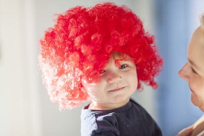 Baby boy wearing red wig